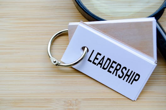 Leadership text on notepad highlighting the core of organizational direction and influence.