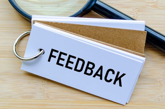 Feedback text on notepad reflecting employee opinions and workplace improvement strategies.