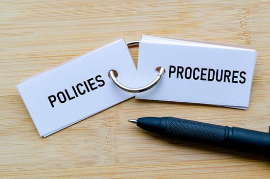 Policies and Procedures text on notepad representing operational guidelines and internal controls.