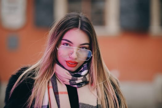 Young woman smiling on red background. Portrait of happy girl smiling in city. Close up of fashion model smile. Happy woman in sunglasses looking in camera