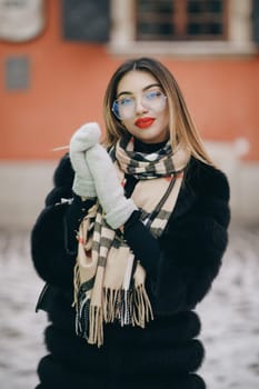 Closeup joyful girl posing on camera. Portrait of smiling female face looking camera outdoor. Close up blonde hair woman feeling happy at city background. Laughing woman portrait.