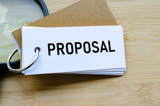 Proposal text on notepad denoting submission of ideas, business bids, or plans.