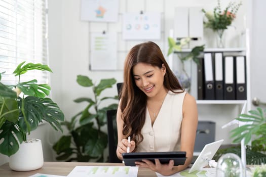 A cheerful professional engages with sustainable design concepts on her tablet, promoting teamwork and innovation in eco-friendly projects.