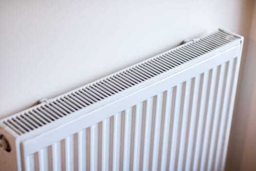 A sleek white baseboard radiator that offers efficient heating for contemporary interiors with style and grace