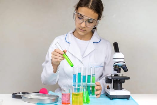 Laboratory research test tubes reagents and microscope. Selective focus. people.