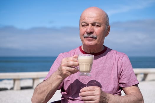 Elderly Man with Mustache Drinking Coffee at Outdoor Cafe on Vacation near sea