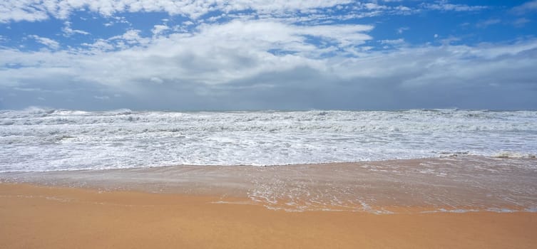 Very rough seas whipped up by the winds of an approaching cyclone with rain on the horizon