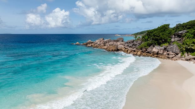 A pristine coastline with clear water and beach with white sand. La Digue, Seychelles.