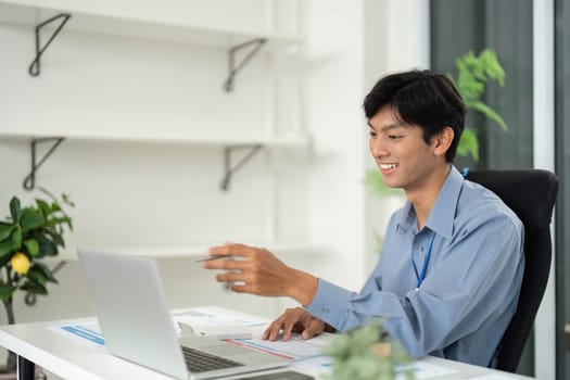 A smiling young professional engages in a virtual presentation, reflecting the shift towards remote work and digital communication.