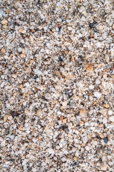 texture of the sand on the beach is macro. Background with a sand pattern with pebbles on the beach by sea