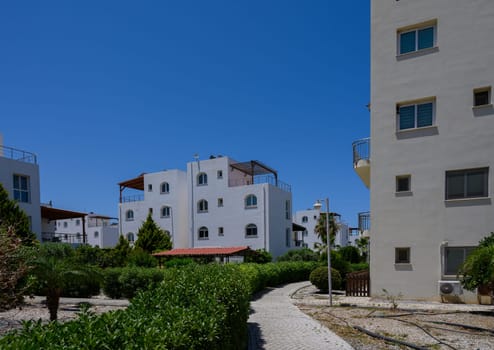 Modern white houses in a quiet coastal residential community near the Mediterranean Sea.
