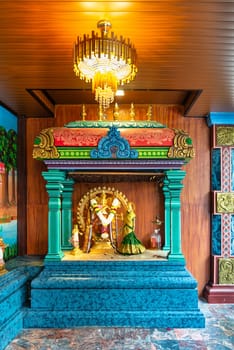 Kuala Lumpur, Malaysia - Feb. 16, 2025: Ornate traditional colorful Hindu altar with golden statue of Lord Shiva as Nataraja and other deities, at Sri Maha Mariamman Temple