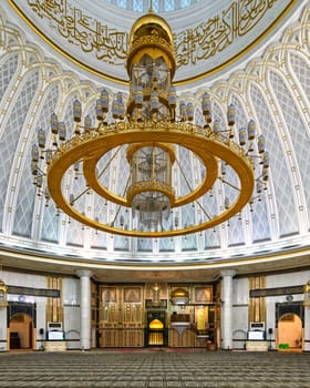 The Jame Asr Hassanil Bolkiah Mosque is observed in Bandar Seri Begawan, Brunei Darussalam. A large, golden chandelier hangs from the decorated ceiling with beautiful Islamic art and design elements