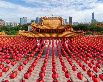Stunning architecture of Thean Hou Temple in Kuala Lumpur, Malaysia, adorned with bright red lanterns and surrounded by a modern city skyline