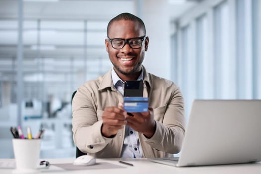 Man Using Mobile Phone To Take Photo Of Credit Card. Possible Professions: Online Shopper, Photographer