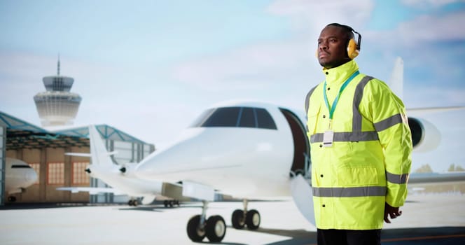 African American Aircraft Maintenance Worker On Runway At Airport.
