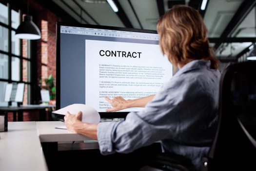 Analyzing Business Documents: Woman Insuring Agreement Paperwork On Online System