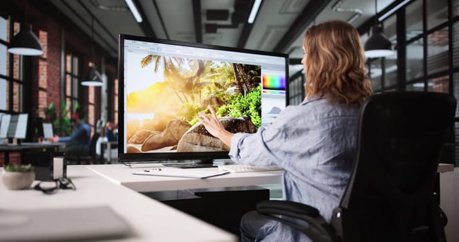 Female Graphic Designer Editing Web Photos On Multiple Computer Screens