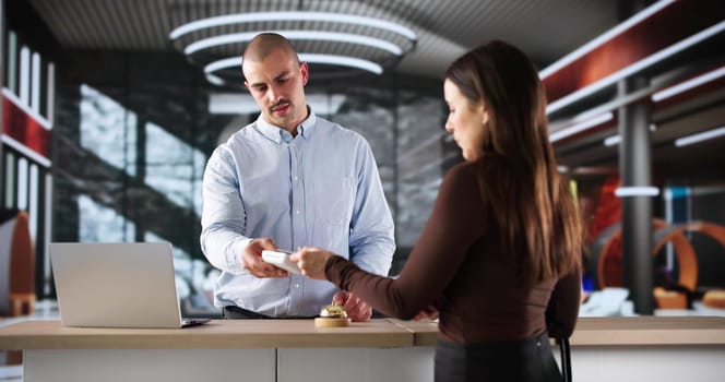 Busy Hotel Concierge Manages Guests With Professionalism And Courtesy