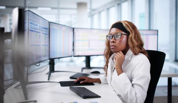 An African American Nurse Types Medical Codes Into Hospital Bill.