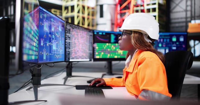 African American Woman Engineer Checking SCADA Control In Rocket Center.
