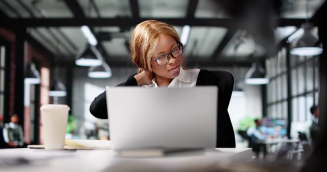 African American Woman Working At Desk: Neck Pain Relief Therapy