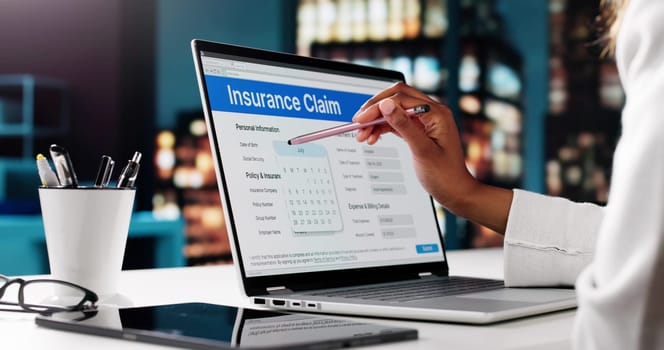 African American Woman Completing An Online Insurance Application For Life Policy