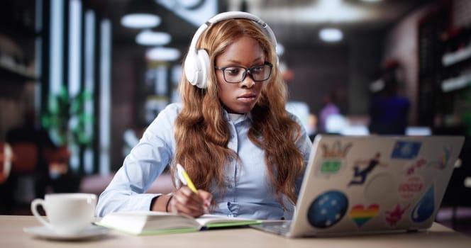 Busy Businesswoman Ordering Coffee While Working On Laptop Online At Cafe