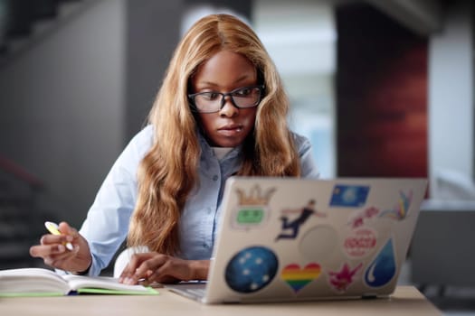African American Graphic Designer Reviews Online Music Courses On Laptop.