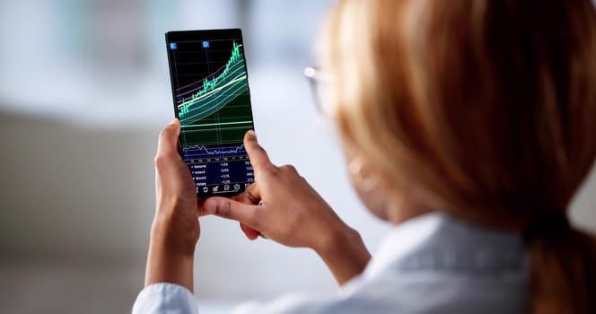 African American Woman Using Smartphone To Trade On Stock Exchange.