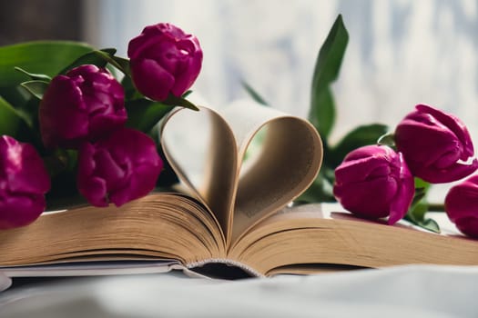 Heart shaped book pages for romantic love greeting card template. Fresh bouquet of pink tulip flowers. Gift present idea for holiday birthday 8 March Mother's Day Valentine's day Women's Day. Copy space