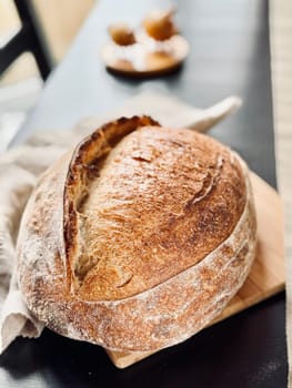 close view of a freshly baked sourdough bread with a textured, golden crust. High quality photo