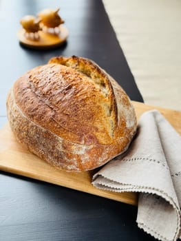 close view of a freshly baked sourdough bread with a textured, golden crust. High quality photo