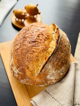 close view of a freshly baked sourdough bread with a textured, golden crust. High quality photo