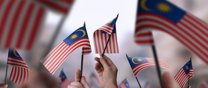 Malaysia flags in their hands on a blurred urban background. The photo illustration was created without the use of artificial intelligence, only using Photoshop.