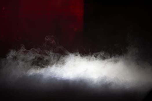Smoke stage illuminated by a beam of light.