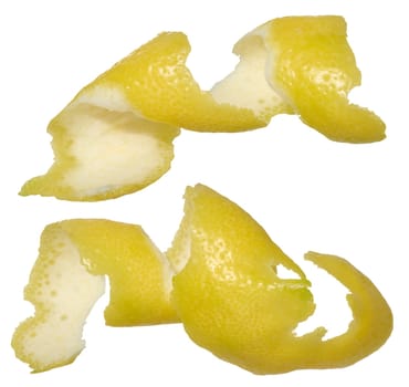 Two twisted strips of lemon peel showing the bright yellow outside and white inside. Close-up of the peel on an isolated background.