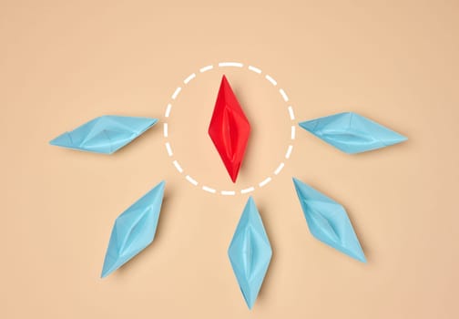 Leadership and individuality concept. One red origami boat surrounded by six blue boats on a beige background. The red boat is highlighted with a dotted circle