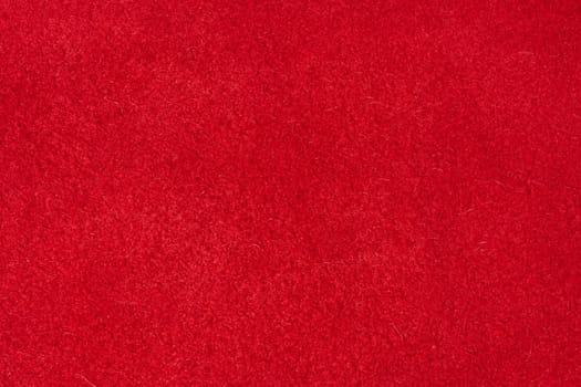 Close up of rich red suede showing the soft, shaggy surface texture with visible fibers