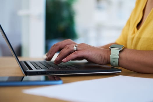A professional individual working on a laptop from a home setup. This setting emphasizes productivity, modern technology, and a balanced lifestyle within a comfortable home environment.