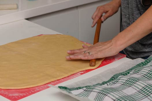 Traditional Home Baking – Woman Preparing Dough with Rolling Pin in Kitchen