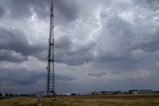 Telecommunication tower for mobile network coverage standing on a hill in Cyprus against a clear sky, ensuring signal strength in rural and urban areas.