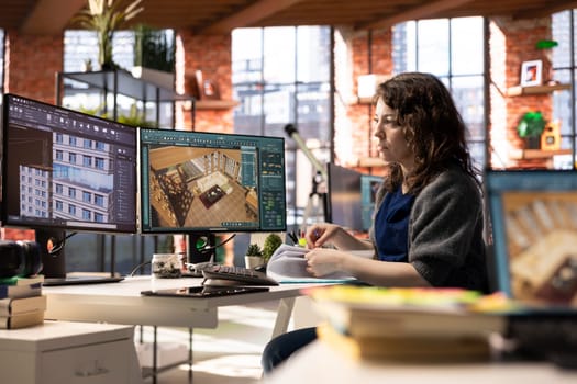 Freelancer designer decorates an apartment floor plan on a computer, using architectural software to configure elements. Woman uses interface to enable rendering and 3D modeling.