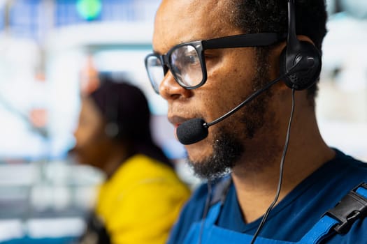 Helpline operator troubleshooting errors in solar production systems, employee providing support for photovoltaic malfunctions or technical issues in renewable energy industrial factory.