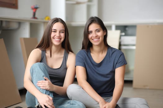 Front view portrait of two happy roommates posing in a house under reformation