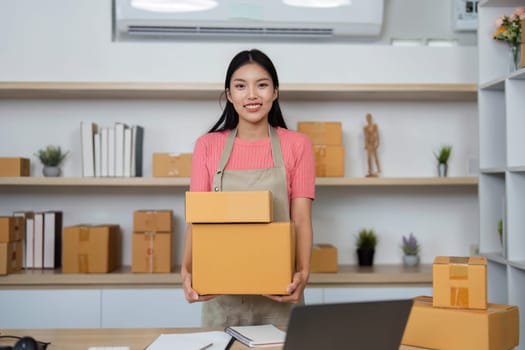 A young entrepreneur showcases her packages in a home office, highlighting the daily operations of her small business.