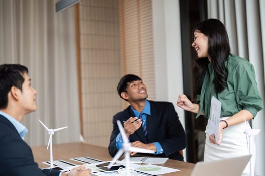 A dynamic group collaborates on ESG strategies, emphasizing sustainability and responsible practices in a vibrant office environment.