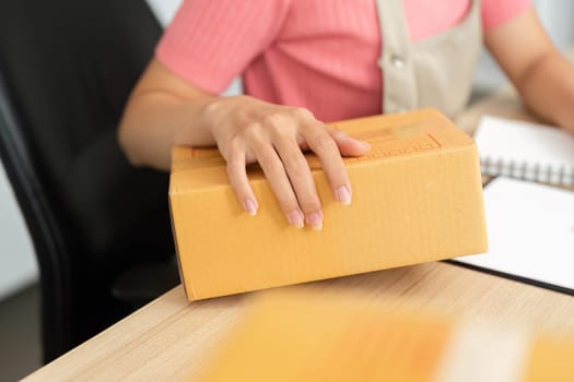 An entrepreneur managing inventory, showcasing efficient small business practices with a focus on packaging and organization.