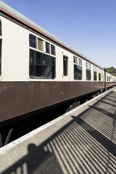 Royal Tunbridge Wells, UK - Apr 29, 2025 - Perspective view of Brown and cream railway carriages at Tunbridge Wells railway station. use it as your Wallpaper, Poster and Copy space, Selective focus.