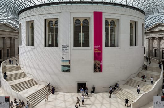London, UK - May 31, 2025 - People and tourists visitors inside The Queen Elizabeth II Great Court or the Great Court has a gridshell roof covered with panels of glass over the entire courtyard situated in the centre of the Great Court of the British Museum. use it as your Wallpaper, Poster and Space for text, Selective focus.